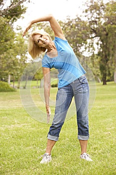 Senior Woman Exercising In Park