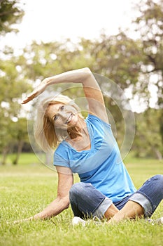 Senior Woman Exercising In Park