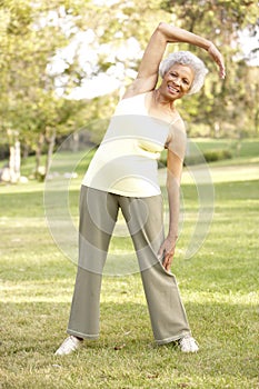 Senior Woman Exercising In Park