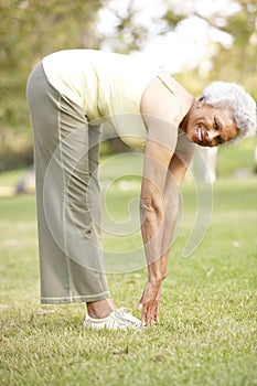 Senior Woman Exercising In Park