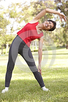 Senior Woman Exercising In Park