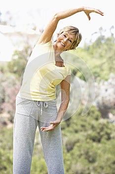 Senior Woman Exercising In Park