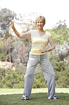 Senior Woman Exercising In Park