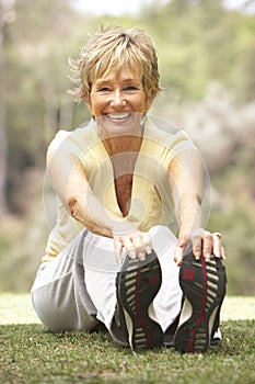 Senior Woman Exercising In Park