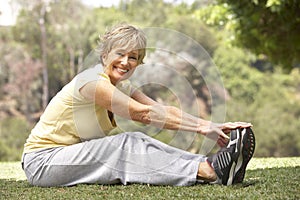 Senior Woman Exercising In Park