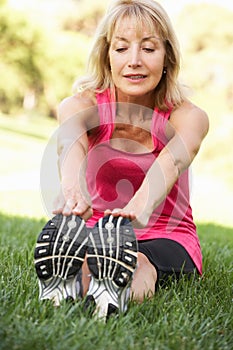 Senior Woman Exercising In Park