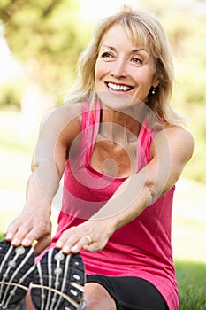 Senior Woman Exercising In Park