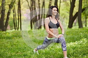 Senior woman exercising in park while listening to music.