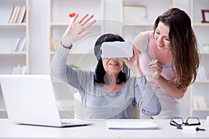 The senior woman experiencing virtual reality glasses