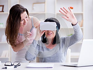 Senior woman experiencing virtual reality glasses