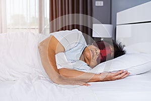 Senior woman with eye mask sleeping on a bed