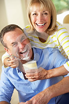 Senior Woman Feeding Husband Ice Cream