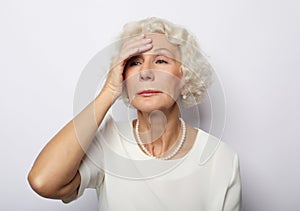 Senior woman feeling blue worried about problems, pensive upset sad middle aged grey haired lady