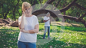 Senior woman feeling depressed after having a argument with her husband outdoor