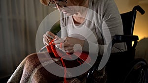 Senior woman feeling desperate of bad sight to knit, eye-illness, hopelessness