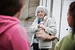 Senior Woman Feeling Intimidated By Teenage Girls