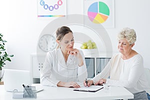 Senior woman filling medical information