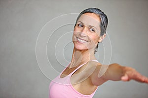 Senior woman, fitness and arm stretching for yoga in studio with mockup for health, balance and exercise on wall