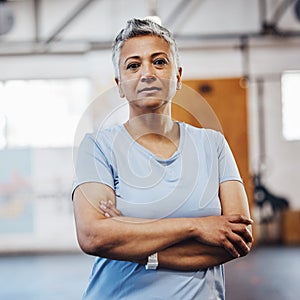 Senior woman, fitness and portrait at gym after exercise, training or workout. Serious old person with arms crossed for