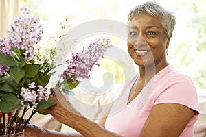 Senior Woman Flower Arranging At Home