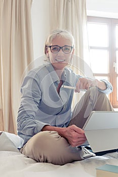 Senior woman freelancer in her study with computer