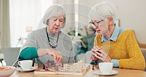 Senior woman, friends and playing chess on table for social activity, decision or strategy game at home. Elderly women