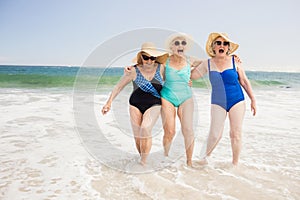 Senior woman friends playing in water