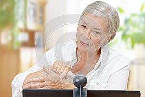 Senior woman webcam video call dermatologist  photo