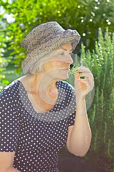 Senior woman garden smelling aroma