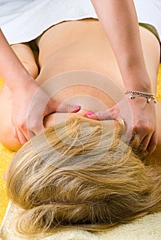 Senior woman getting a deep shoulders massage