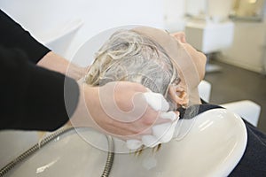 Senior Woman Getting Hair Washed In Parlor