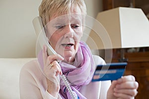 Senior Woman Giving Credit Card Details On The Phone