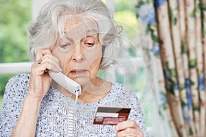 Senior Woman Giving Credit Card Details On The Phone