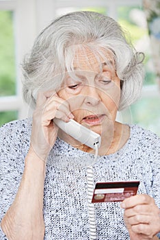 Senior Woman Giving Credit Card Details On The Phone