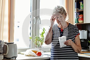 Senior woman going through her receipts at home photo