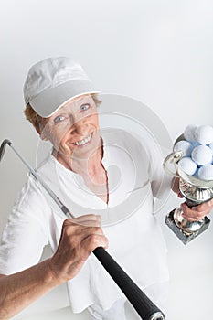 Senior woman with a golf trophy