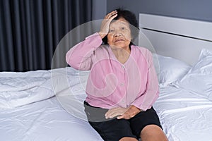 Senior woman got a headache on bed