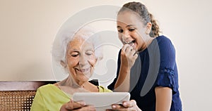 Senior Woman And Grandchild With Tablet Computer For Internet