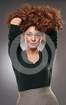 Senior woman on gray background photo