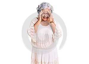 Senior woman with gray hair wearing bohemian style with hand on head, headache because stress