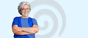 Senior woman with gray hair wearing casual clothes and glasses happy face smiling with crossed arms looking at the camera
