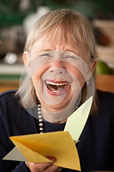 Senior woman with greeting card photo