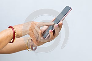 Senior woman hand holding mobile phone