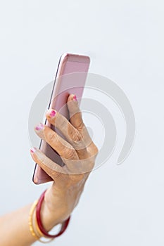 Senior woman hand holding mobile phone