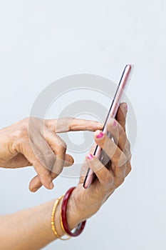 Senior woman hand holding mobile phone