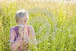 Senior woman with handkerchief in the grass