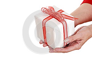 Senior woman hands holding christmas gift