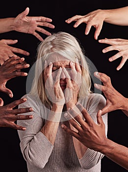 Senior woman, hands or mental health stress on black background in studio with guilt, fear or schizophrenia disorder