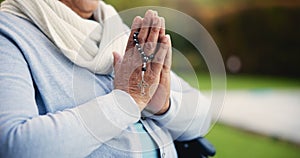 Senior, woman or hands praying with rosary for religion, worship and support for jesus christ in garden of home. Elderly