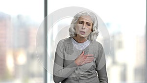 Senior woman having chest pain.